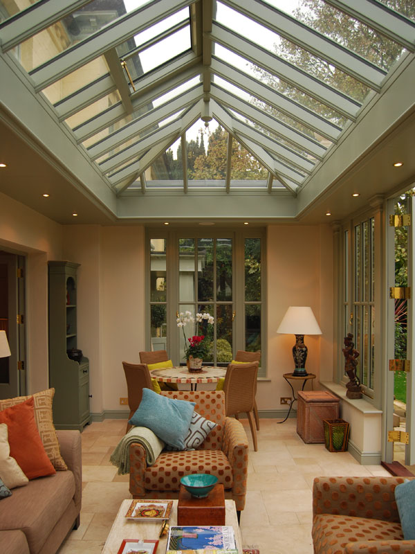 A rectangular roof lantern defines a sitting area in a pretty orangery extension
