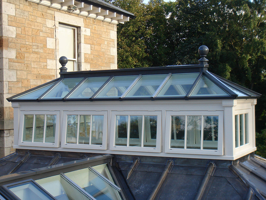 Beautiful roof lantern with side frames crowning a lead roof
